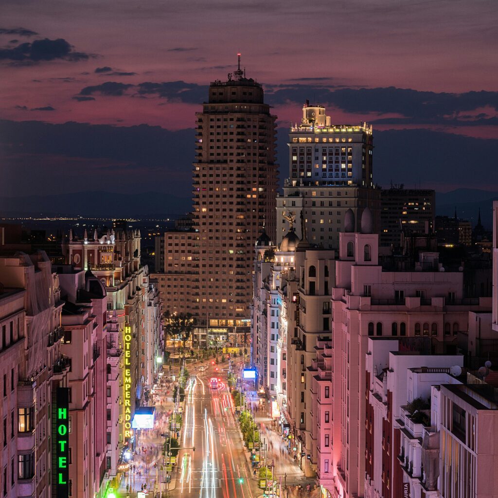 Stunning aerial view of Madrid's Gran Via at night, showcasing illuminated streets and iconic architecture.